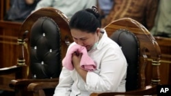 FILE - Ethnic Chinese woman Meliana weeps during her sentencing hearing at a district court in Medan, North Sumatra, Indonesia, Aug. 21, 2018.