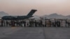 Evacuees wait to board a Boeing C-17 Globemaster III during an evacuation at Hamid Karzai International Airport, Kabul, Afghanistan, Aug. 23. (US Marine Corps photo)