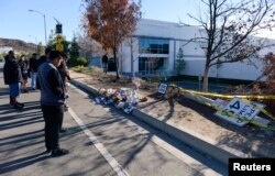 Fans place flowers at the scene of the car crash where actor Paul Walker was killed in the Santa Clarita area of Los Angeles December 1, 2013. Walker, best known for his roles in the "Fast and the Furious" action movies, died on November 30 in a car crash