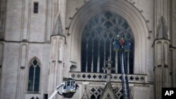 Fire fighters brigade work to extinguish the blaze at the Gothic St. Peter and St. Paul Cathedral, in Nantes, western France, July 18, 2020.
