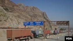 FILE - Trucks carrying containers stand idle at the closed Torkham border crossing between Pakistan and Afghanistan. 