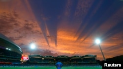 India's Shikhar Dhawan looks to the sky from his fielding position during sunset in their Cricket World Cup match against Pakistan in Adelaide, February 15, 2015. 