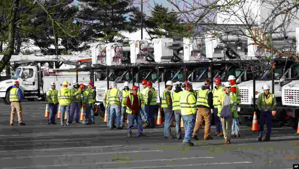 Crews from as far away as Missouri and Illinois gather in a parking lot used as a staging area at the Quaker Bridge Mall in Lawrence Township, N.J., November 1, 2012.