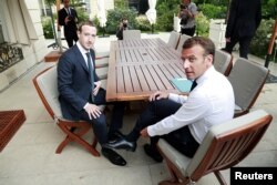 FILE - Facebook's founder and CEO Mark Zuckerberg meets with French President Emmanuel Macron at the Elysee Palace after the "Tech for Good" summit, in Paris, France, May 23, 2018.