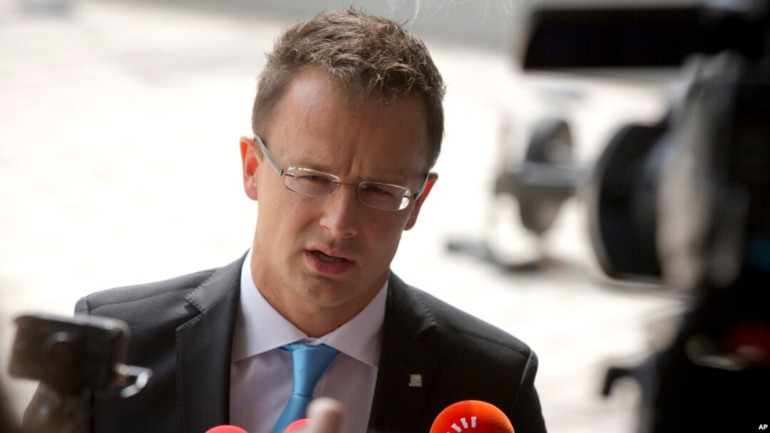 FILE - Hungarian Foreign Minister Peter Szijjarto speaks with the media as he arrives for a meeting of EU foreign ministers at the EU Council building in Luxembourg, Sept. 4, 2015