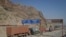 FILE - Trucks carrying containers stand idle at the closed Torkham border crossing between Pakistan and Afghanistan. The closure of border crossings has further raised tensions between the two neighbors