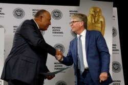 Egypt's Foreign Minister Sameh Shoukry and Manhattan District Attorney Cyrus R. Vance Jr. greet each other during a news conference to announce the return of the gold coffin of Nedjemankh to the people of Egypt, in New York City, Sept. 25, 2019.