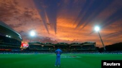 India's Shikhar Dhawan looks to the sky from his fielding position during sunset in their Cricket World Cup match against Pakistan in Adelaide, February 15, 2015. REUTERS/David Gray (AUSTRALIA - Tags: SPORT CRICKET TPX IMAGES OF THE DAY) - RTR4PN3K