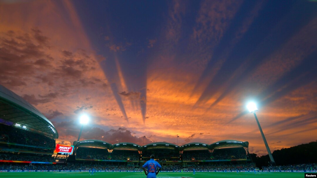 India's Shikhar Dhawan looks to the sky from his fielding position during sunset in their Cricket World Cup match against Pakistan in Adelaide, February 15, 2015. 
