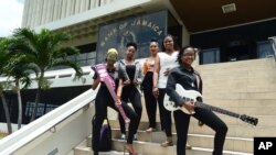 Members of the all-female band ADAHEZ, Chevanese Palmer, from left, Karissa Palmer, Gabeana Campbell, Tashana Barnett and Shadeeka Daughma, pose for a photo on the steps of the Bank of Jamaica, in Kingston, June 13, 2019. 
