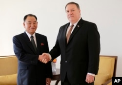 FILE - Kim Yong Chol, left, former North Korean military intelligence chief and one of leader Kim Jong Un's closest aides, shakes hands with U.S. Secretary of State Mike Pompeo during a meeting, May 31, 2018, in New York.