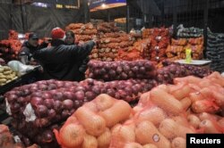 People talk at the Mercado Central, the city's largest wholesale central market which receives produce from the entire country, outside of Buenos Aires, Argentina on June 23, 2022. (REUTERS/Mariana Nedelcu)