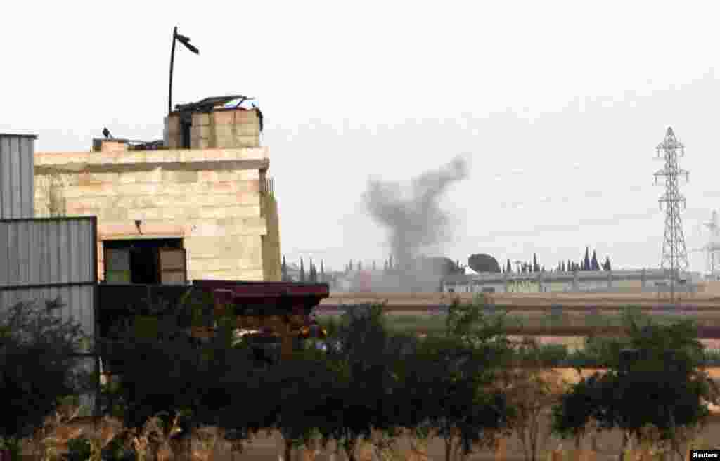 Smoke is seen after pro-government forces shelled the outskirts of Atareb, in Idlib governorate, Syria, October 24, 2012.