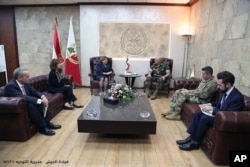 In this photo released by the Lebanese army official website, Lebanese Army Commander Gen. Joseph Aoun, center right, meets with U.S. Undersecretary of the Air Force for International Affairs Heidi Grant and U.S. Ambassador to Lebanon Elizabeth Richard, second left, at the Lebanese Defense Ministry in Yarzeh near Beirut, Nov. 8, 2017. Washington said its support for the Lebanese government would not change following the resignation of Prime Minister Saad al-Hariri.