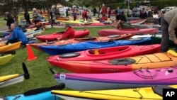 Activists who oppose Royal Dutch Shell's plans to drill for oil in the Arctic Ocean prepare their kayaks for a protest in Seattle's Elliott Bay, May 16, 2015.