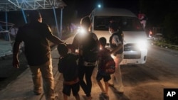 Mexican immigration agents detain a Central American migrant who is part of a caravan heading north in Huixtla, Chiapas state, Mexico, Sept. 5, 2021.