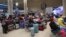 Passengers wait at Ben Gurion Airport near Tel Aviv, Israel, on October 7, 2023, as flights are canceled because of the Hamas surprise attack.