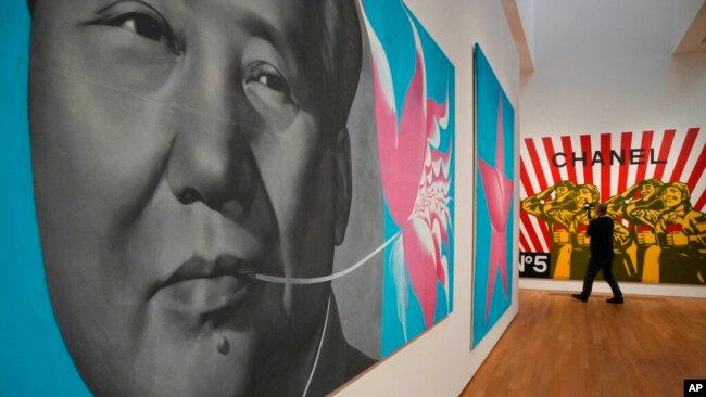 FILE - A painting titled 'Rouge 1992' created by Chinese artist Li Shan, is seen during a media preview in the West Kowloon Cultural District of Hong Kong, Nov. 11, 2021.
