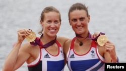 Britain's Helen Glover and Heather Stanning stand with their gold medals after the women's pair Final A at Eton Dorney during the London 2012 Olympic Games August 1, 2012.