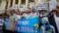 Demonstrators, holding signs to protest against Taiwanese enterprise Formosa Plastic and environmental-friendly messages, say they are demanding cleaner waters in the central regions after mass fish deaths in recent weeks, in Hanoi, Vietnam, May 1, 2016.
