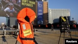 Những chiếc áo phao và biểu ngữ được đặt trước trụ sở của Ủy ban châu Âu trong cuộc biểu tình của Ân xá Quốc tế, trước buổi họp giữa EU-Thổ Nhĩ Kỳ ở Brussels, Bỉ, ngày 17/3/2016.