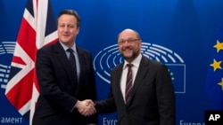 British Prime Minister David Cameron, left, is greeted by European Parliament President Martin Schultz at the European Parliament in Brussels, Belgium, Feb. 16, 2016.