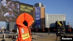 Lifejackets are pictured in front of the European Commission headquarters in Brussels during a protest by Amnesty International to demand the European Council protect the human rights of the refugees within the EU-Turkey migration deal, March 17, 2016.