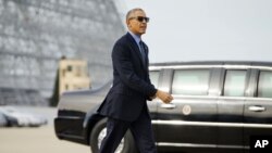 President Barack Obama walks across the tarmac after greeting guests before boarding Air Force One at Moffett Federal Airfield in Mountain View, Calif., Thursday, Feb. 11, 2016.
