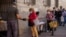 People collect food donated by volunteers and members of the Catholic Servants of Jesus congregation in Madrid, Spain, Oct. 8, 2020.