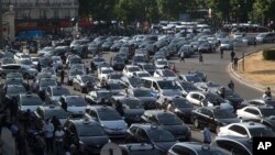 Taxis gather at a major entrance to Paris, France, June 25, 2015.