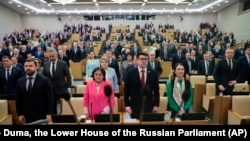 Russian lawmakers listen to the national anthem prior to a session at the State Duma, the lower house of the Russian Parliament in Moscow, Russia, Dec. 17, 2024.