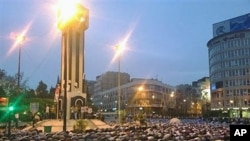 In this citizen journalism image acquired by The AP, Syrians pray in Clock Square in the center of the city of Homs, Syria, April 18 2011