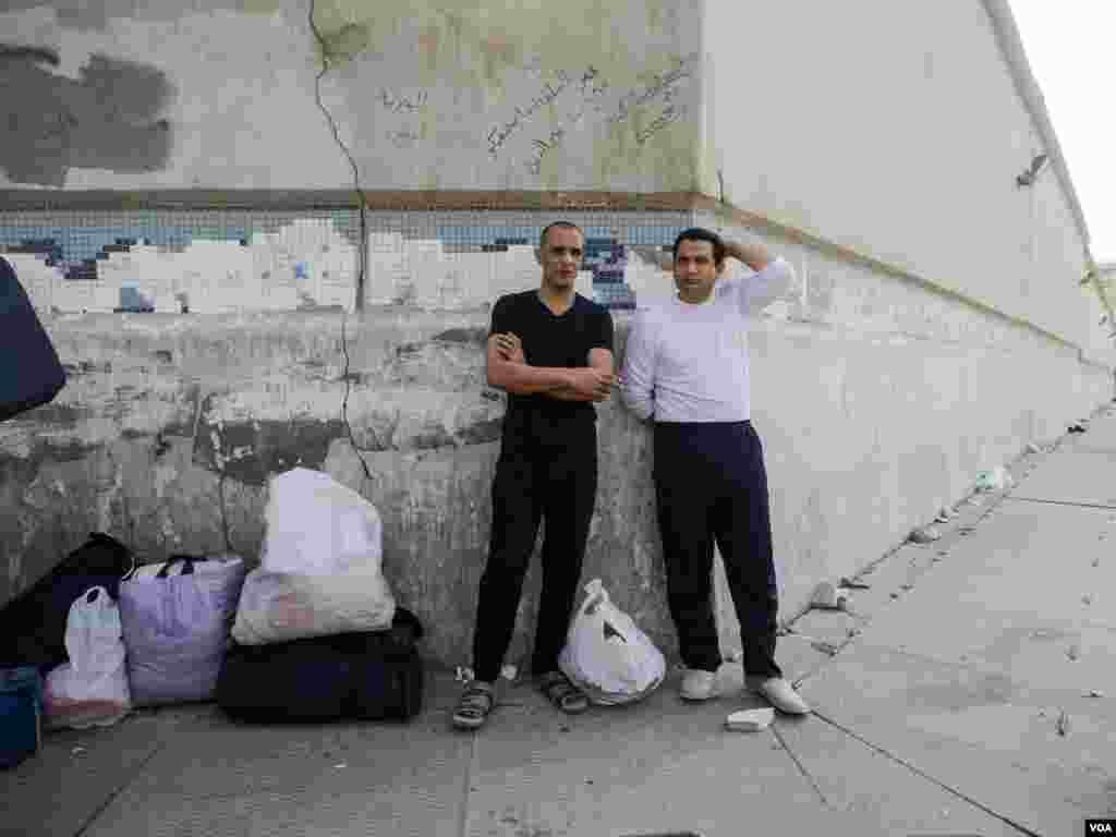 Two of the newly released prisoners, Waled Essam (L) and Mohamed Salah, are waiting for their families. &ldquo;We expected our families or friends to be waiting for us, but may be they are late,&rdquo; said Waled. &ldquo;We will wait for them or borrow some money and clothes in order to go back home,&rdquo; he said, Cairo, Egypt, Tuesday, March 14, 2017. (H. Elrasam/VOA)