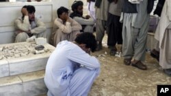 An Afghan mourns during the burial ceremony for Ahmad Wali Karzai, President Hamid Karzai's brother who was killed by a bodyguard on Tuesday, in Kandahar province July 13, 2011.