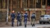 FILE - Ugandan security forces patrol on a street in Kampala, Uganda, Nov. 19, 2020. Rights activists are accusing the government of silencing critics after police arrested opposition party president Joseph Kabuleta on Nov. 28, 2022.