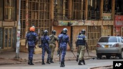FILE - Ugandan security forces patrol on a street in Kampala, Uganda, Nov. 19, 2020. Rights activists are accusing the government of silencing critics after police arrested opposition party president Joseph Kabuleta on Nov. 28, 2022.