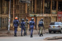 FILE - Ugandan security forces patrol on a street in Kampala, Uganda, Nov. 19, 2020.