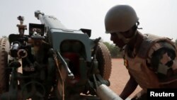 FILE - A Malian soldier is pictured during a training session on a D-30 howitzer with the European Union Training Mission (EUTM), to fight jihadists, in the camp of Sevare, Mopti region, in Mali on March 23, 2021. 