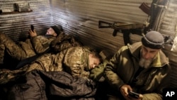 Servicemen of the 24th Mechanized Brigade rest in a shelter on the front line near Chasiv Yar town, in Donetsk region, Ukraine, Dec. 12, 2024. (Oleg Petrasiuk/Ukrainian 24th Mechanized Brigade via AP)