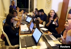 FILE - Beirut Madinati candidates and delegates cheer while monitoring ballot counts for the municipality elections after closing the polling stations during Beirut's municipal elections, Lebanon, May 8, 2016.