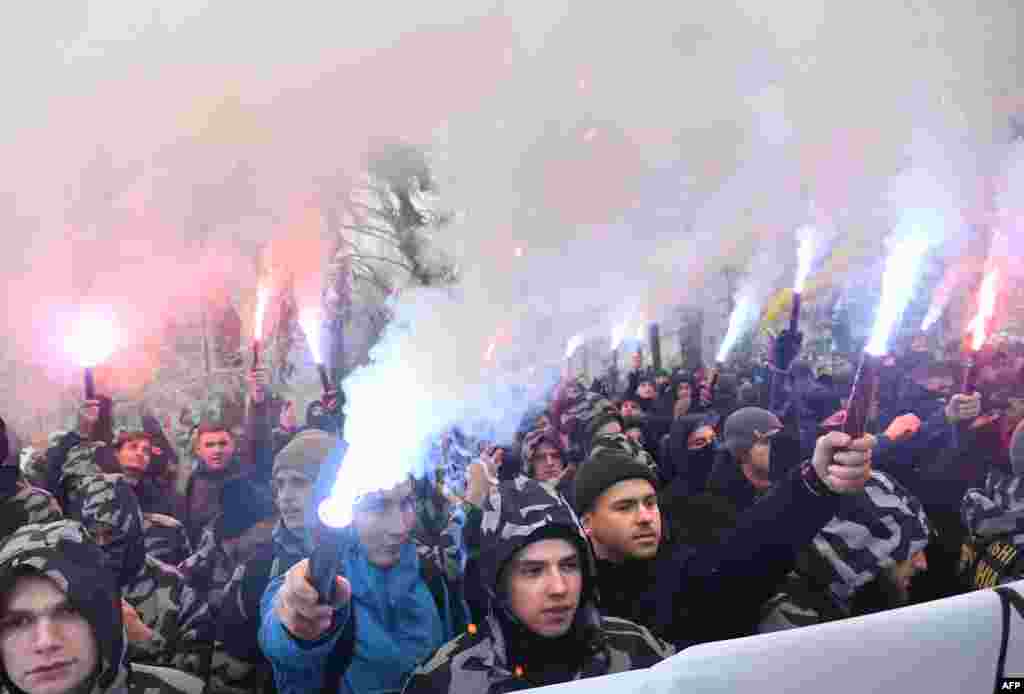 Activists of Ukrainian far-right groups hold flares during a rally in front of the Ukrainian parliament in Kyiv as they demand to set martial law in the country and to cut diplomatic relations with Russia.