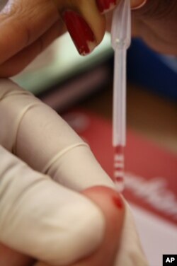 Blood is taken from Marais' finger in order to be tested for the presence of HIV