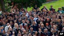 Workers gather during a rally in Minsk, Belarus, Aug. 14, 2020, demanded a new election and called for the release of all who were detained in a brutal police crackdown on demonstrators challenging the official results of Sunday's presidential vote.