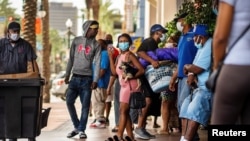 Evacuees from Lake Charles, Louisiana, and surrounding areas are seen outside a hotel in New Orleans, Louisiana, Aug. 28, 2020. The state government has requested hotels make rooms available for those affected by Hurricane Laura.