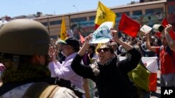 An anti-government demonstrators confronts a soldier in front of Congress in Valparaiso, Chile, Oct. 25, 2019. 