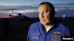 Head of the Russian space agency Roscosmos Dmitry Rogozin addresses the media upon the arrival of Russian cosmonaut Alexey Ovchinin and U.S. astronaut Nick Hague at Baikonur airport, Kazakhstan, Oct. 11, 2018.