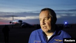 Head of the Russian space agency Roscosmos Dmitry Rogozin addresses the media upon the arrival of Russian cosmonaut Alexey Ovchinin and U.S. astronaut Nick Hague at Baikonur airport, Kazakhstan, Oct. 11, 2018.