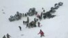 Turkish soldiers and locals rescue people trapped under avalanche in Bahcesaray in Van province, Turkey, in this still image taken from video. (Credit: Ihlas News Agency)