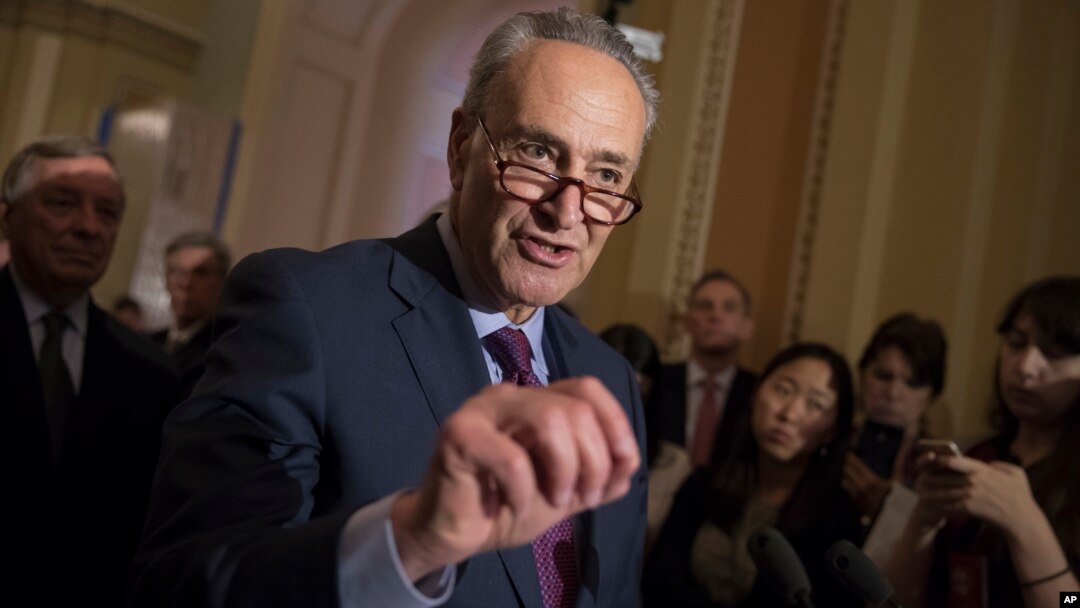FILE - Senate Minority Leader Charles Schumer, D-N.Y., reacts to questions from reporters. 