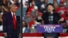 FILE - Tesla CEO and X owner Elon Musk speaks as Republican presidential nominee and former U.S. President Donald Trump looks on during a campaign rally in Butler, Pennsylvania, Oct. 5, 2024. 